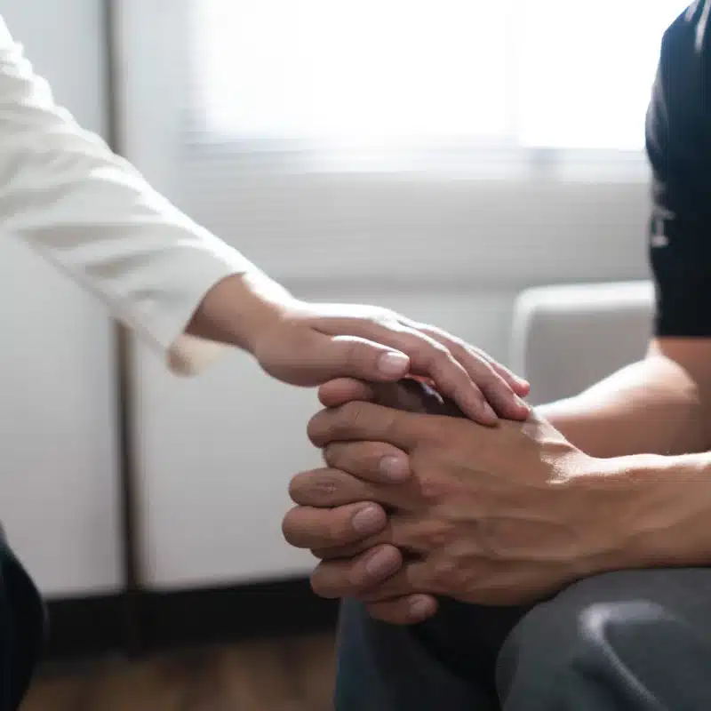 The AA Promises: A person reaching out a hand to provide comfort.