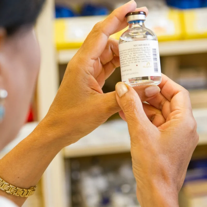 A doctor holding a bottle of vivitrol.